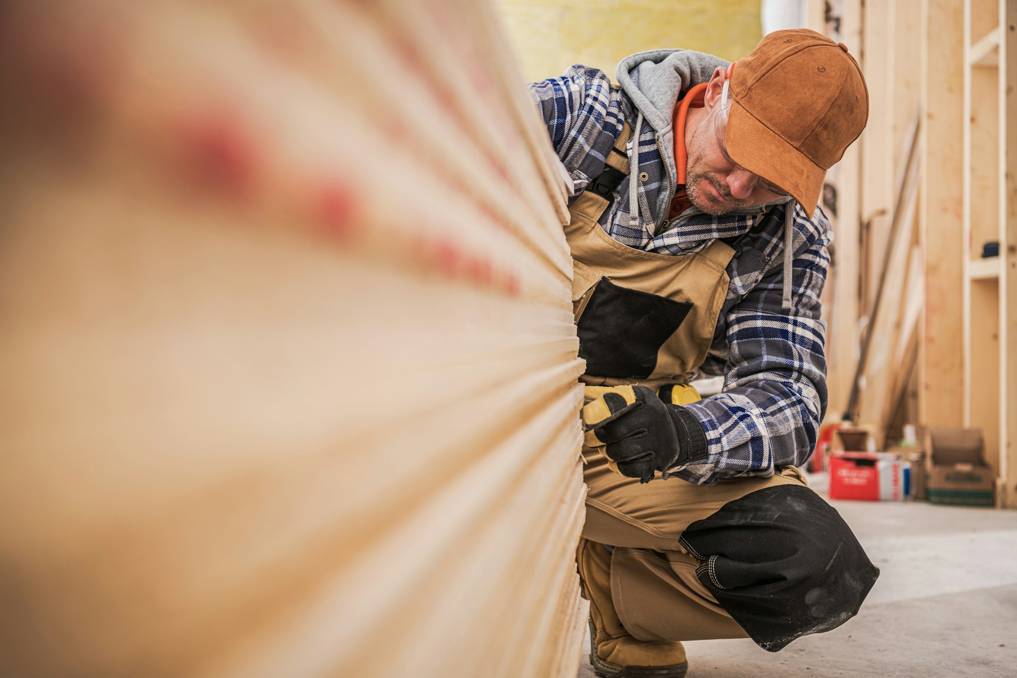 General Construction Contractor Worker Counting Pieces of Drywall Boards